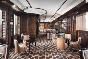 a bar with chairs and tables in a train car at Casa Cipriani Milano in Milan