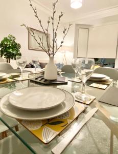 a dining room table with a white plate and glasses at Comfortable Home in Hull in Hull