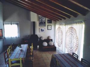 a living room with two tables and a couch at Albergue Casa Vacas in Carriazo