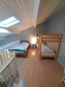 a room with two bunk beds and a skylight at Appartement SOULAC SUR MER À 500 m de la plage N 4 in Soulac-sur-Mer