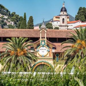 a building with a clock on the side of it at Gabriella in Menton