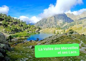 a lake in the mountains with a sign that reads lavalle des meadows at Gabriella in Menton
