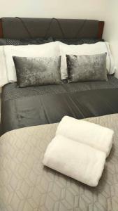 a bed with a white pillow on top of it at Allen’s cozy condo in Davao City