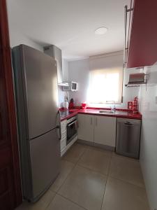 a kitchen with a stainless steel refrigerator and appliances at Paseo Playa de los Estudiantes in Villajoyosa