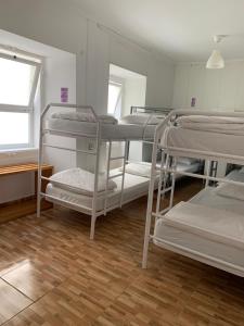 a room with four bunk beds and a window at Place Santa Apolónia in Lisbon