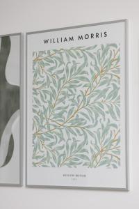 a framed picture of william morris with a green leaf pattern at Metro Bemowo Apartment by Renters in Warsaw