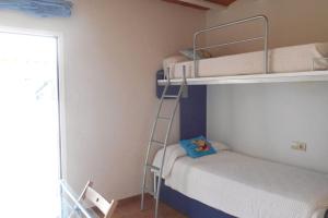 a room with two bunk beds and a ladder at Casa con impresionantes vistas al mar in Tossa de Mar +27 photos