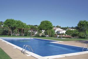 a large swimming pool in a yard with trees at Casa con impresionantes vistas al mar in Tossa de Mar