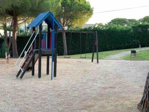 a playground with a slide in a park at Casa con impresionantes vistas al mar in Tossa de Mar
