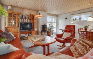 a living room with a couch and a table and chairs at Awesome Home In Middelfart With Wifi And 2 Bedrooms in Middelfart