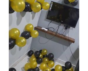 a bunch of gold and black balloons in a room at Siddhi Vinayak Hotel & Marriage Garden, Chandukhedi in Ujjain