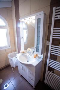 a bathroom with a white sink and a mirror at Casa di Castellano in Corfu