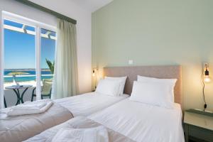 Posteľ alebo postele v izbe v ubytovaní Eolos Apartments