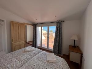 a bedroom with a bed and a large window at Calle Carabeo 57 in Nerja
