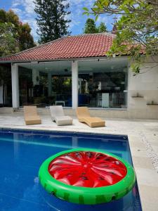 a pool with a red item in the middle of it at Villa Neshama in Canggu