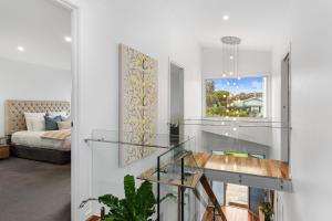 a living room with a glass table and a bed at Luxurious Terrace Hideaway with a Heated Pool in Ocean Grove +24 photos