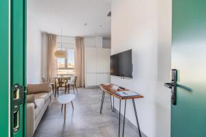 a living room with a couch and a table at CASA DE LA VEGA SUITES in Chiclana de la Frontera