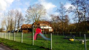 a playground with a red slide in a park at *Engels - Ferienwohnungen in Visquard