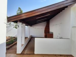 awning on the side of a white building at MX RESIDENCIAL in Jaú