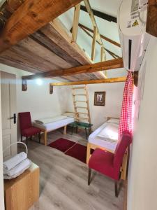 a room with a bed and a chair and a ladder at Konak Dobri Potok in Krupanj