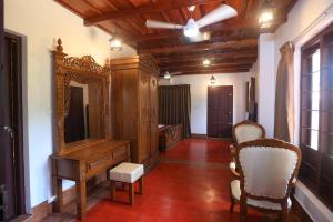 a living room with a dresser and a mirror at Heaven Inn Munnar in Munnar