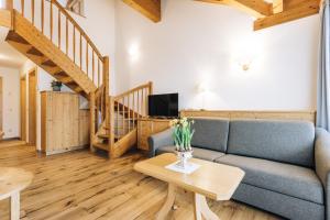 a living room with a couch and a table at Hotel Tenz in Montagna