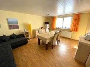 a living room with a table and a couch at Bungalow mit Pool in Pruchten