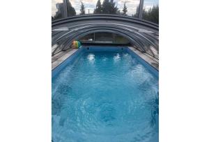 uma piscina com um túnel e água azul em Bungalow mit Pool em Pruchten