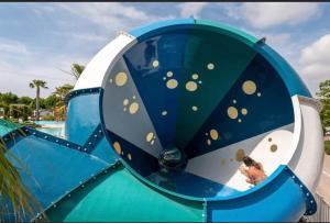 a blue and white slide at a water park at Mobilhome Vias plage dans Camping in Vias