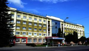 a large building with a clock on the front of it at Hotel Ternopil in Ternopil