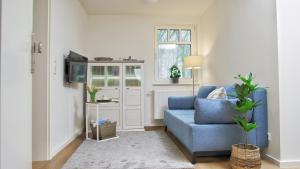 a living room with a blue couch and a window at Quartier2 in Zeven