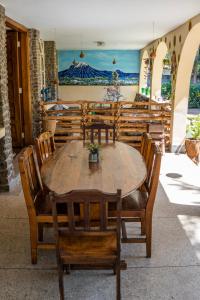 a wooden table and chairs on a patio at Kiwavi Home in Moshi