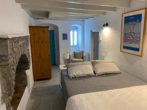 a bedroom with a bed and a fireplace at Little Blue in Chorio, Symi in Symi