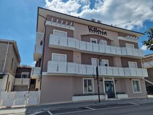 a building with a sign on the side of it at Residence Vittoria in Alba Adriatica