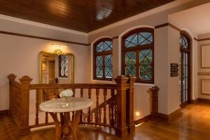 a room with a wooden staircase with a table at The Bellwood Manor in Nuwara Eliya