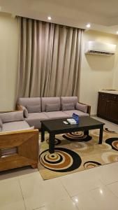 a living room with a couch and a coffee table at فندق مرسى جيزان in Jazan