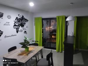 羅薩里奧的住宿－Pichincha rio c cochera cubierta，一间设有桌子和绿色窗帘的用餐室