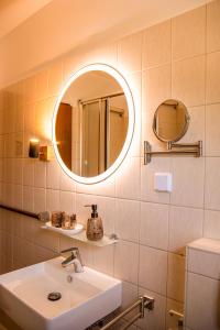 a bathroom with a sink and a mirror at Viktoria‘s Ferienwohnung in Bad Harzburg