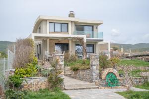 una casa en una colina con una pared de piedra en Villa Eva Dikella, en Mesimvría