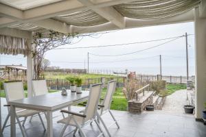 a table and chairs on a patio with a view of the ocean at Villa Eva Dikella in Mesimvría