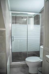 a bathroom with a toilet and a glass shower at Villa Eva Dikella in Mesimvría +48 photos