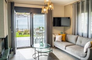 a living room with a couch and a glass table at Villa Eva Dikella in Mesimvría