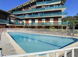 a swimming pool in front of a building at Apartment Grizzly - 2 bedrooms - Ski in/out- Les Gets in Les Gets