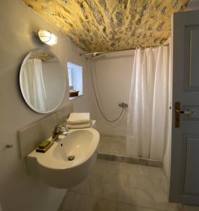 a bathroom with a sink and a mirror and a shower at Little Blue in Chorio, Symi in Symi