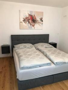 a bed with two pillows on it in a room at Appartement Attergau in Sankt Georgen im Attergau