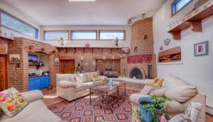 ein Wohnzimmer mit Ziegelwand in der Unterkunft Loba Luna-Come Home To Enchantment in Albuquerque