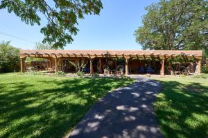 a pavilion with a table and chairs in a park at Loba Luna-Come Home To Enchantment in Albuquerque