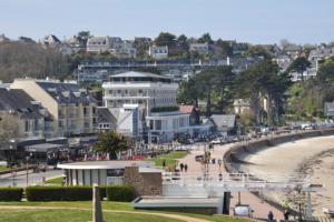 a view of a beach with buildings and a city at Le Ker Bleu in Perros-Guirec