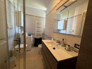 W łazience znajduje się umywalka, toaleta i lustro. w obiekcie Comfort e relax ad Abano Terme - Turen w mieście Abano Terme