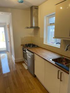 a kitchen with a sink and a stove at Lovely room in Bristol 5 in Bristol